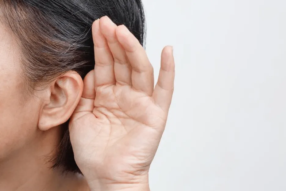Lady with her hand beside ear